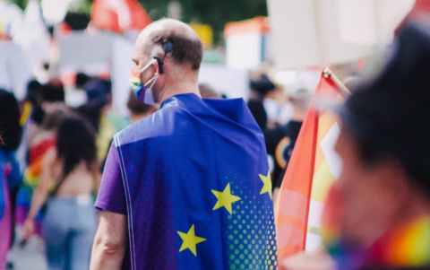 Man with EU Flag on his back, during Pride Parade